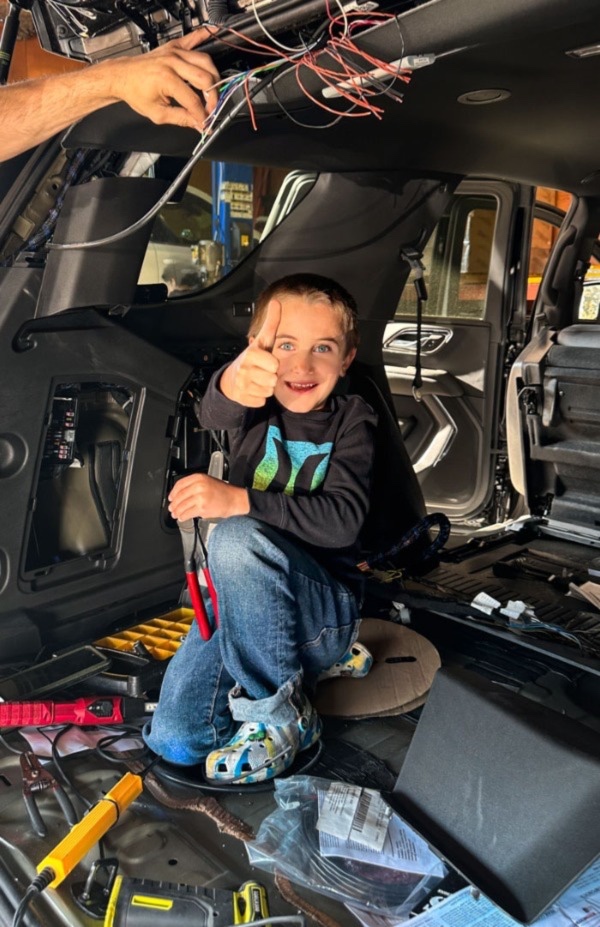 A young visitor giving a thumbs-up during a workshop visit