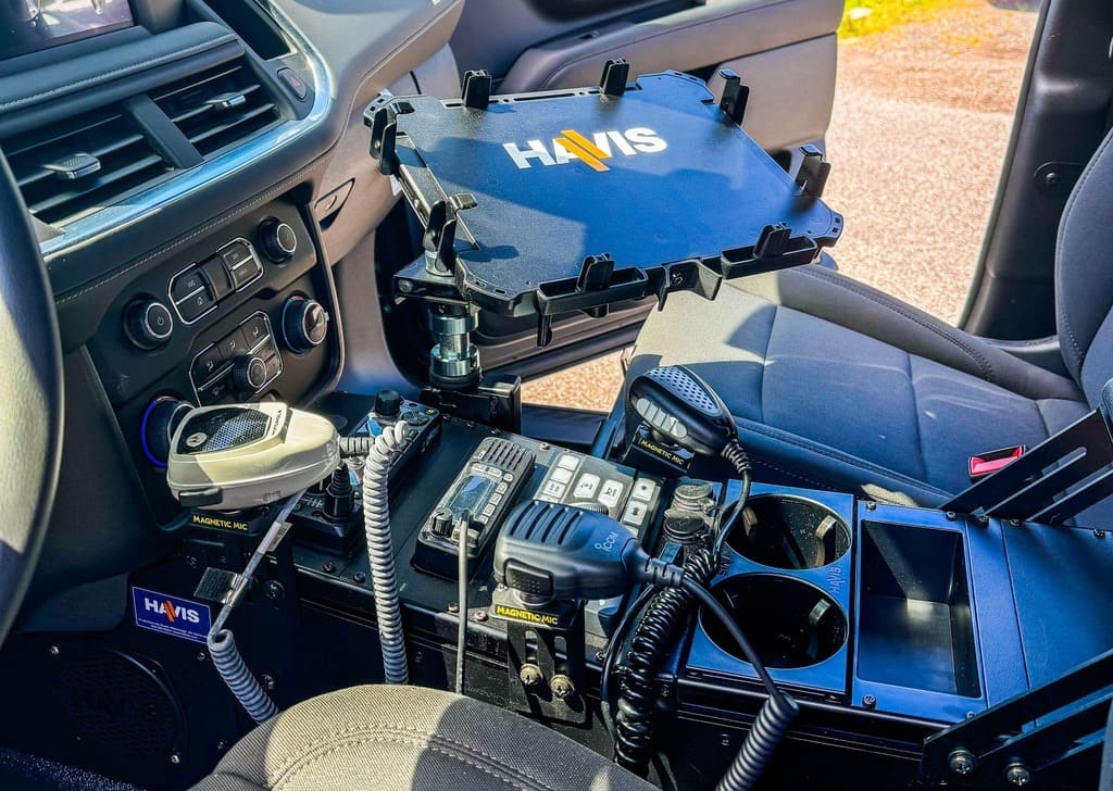 Vehicle console with radio controls, microphones and a tablet mount